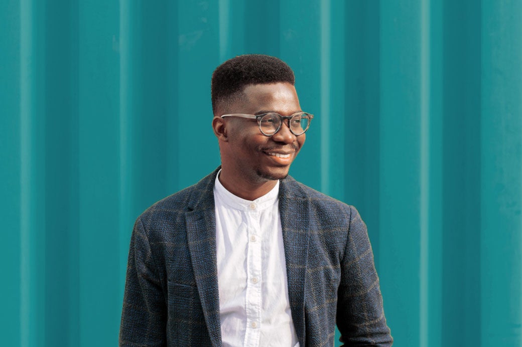 Smiling young man wearing glasses.