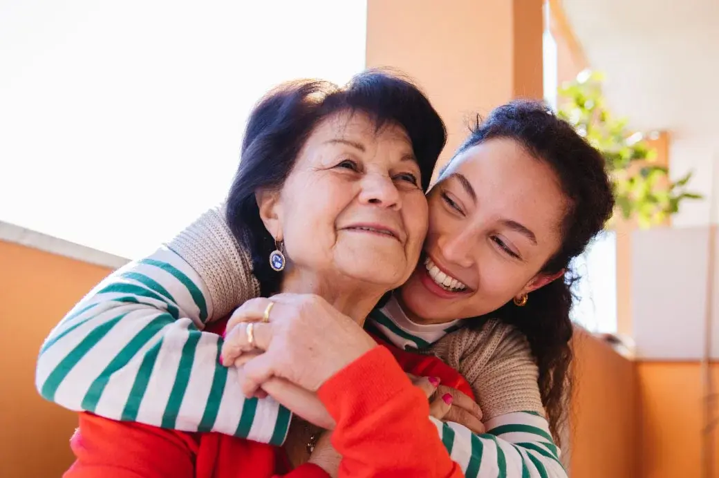 Young woman hugging an older woman