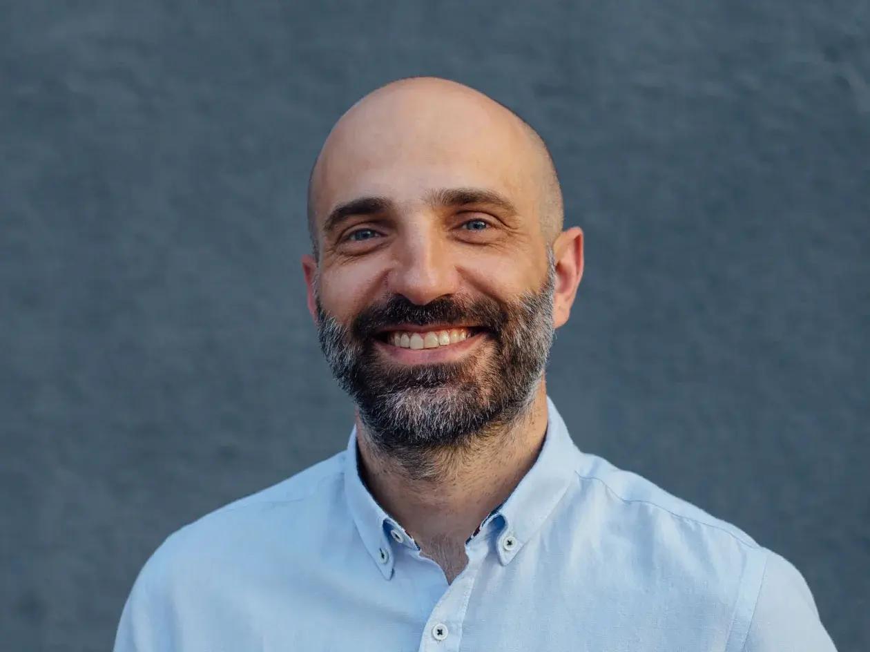 Headshot of smiling Chief Experience Officer.