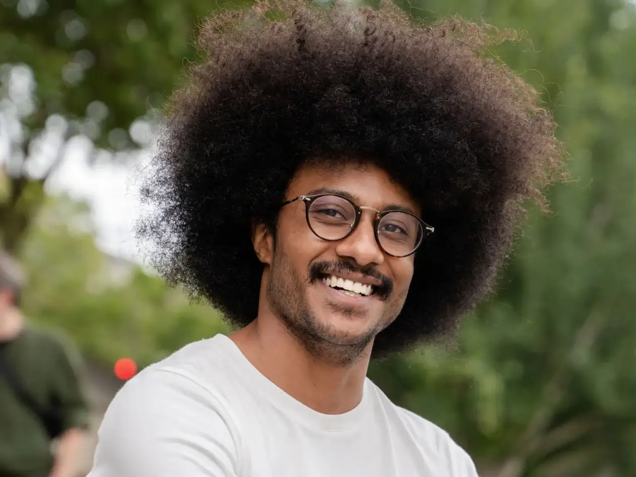 Smiling man wearing glasses.