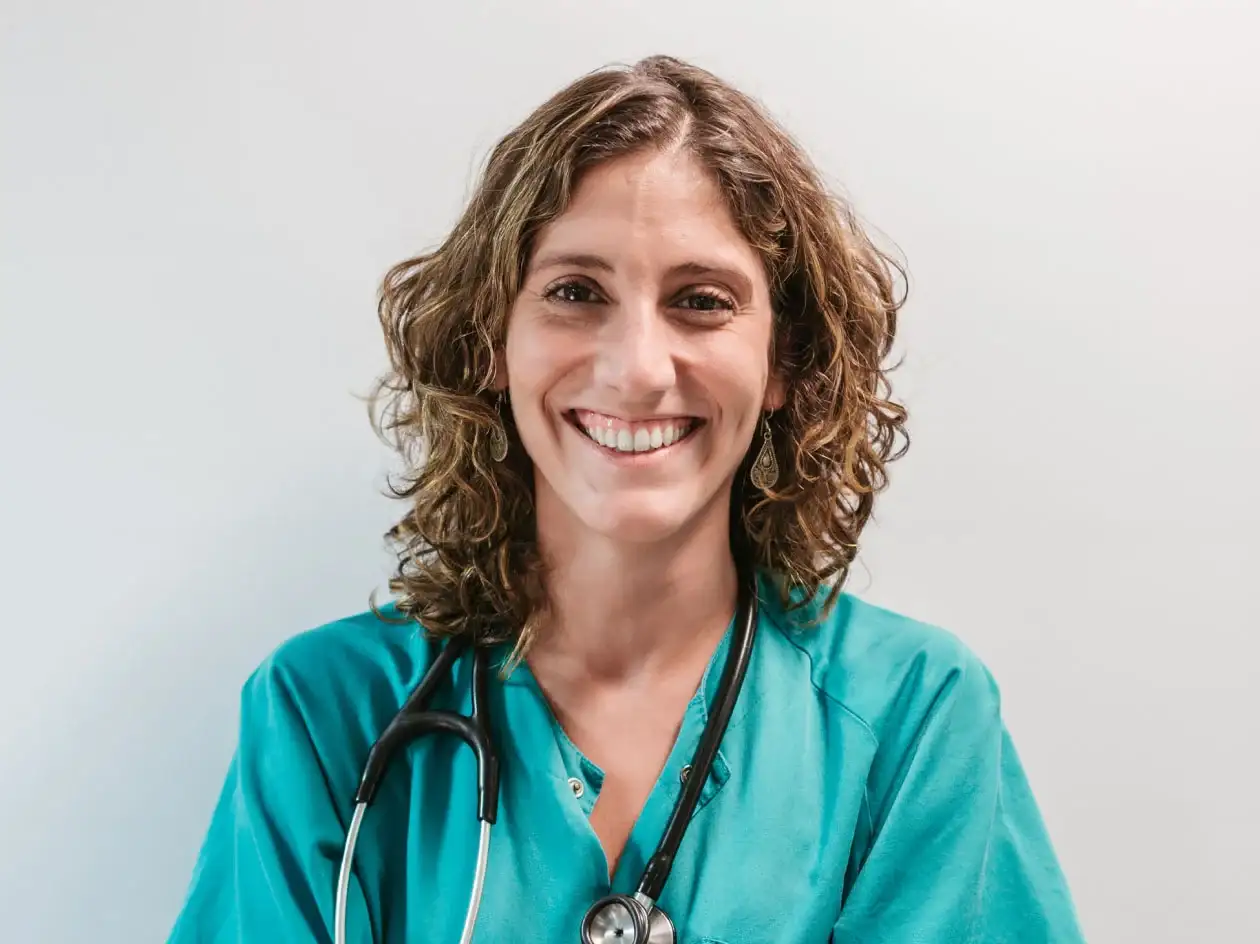 Smiling healthcare provider with stethoscope around her neck.