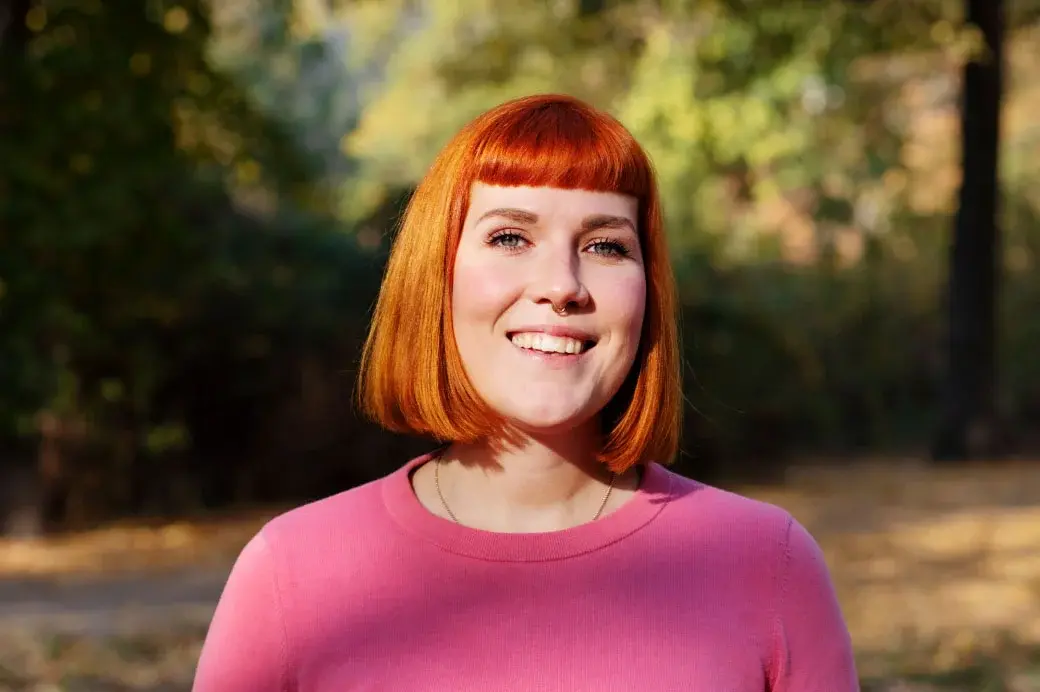 Headshot of smiling woman happy with improving care and lowering costs