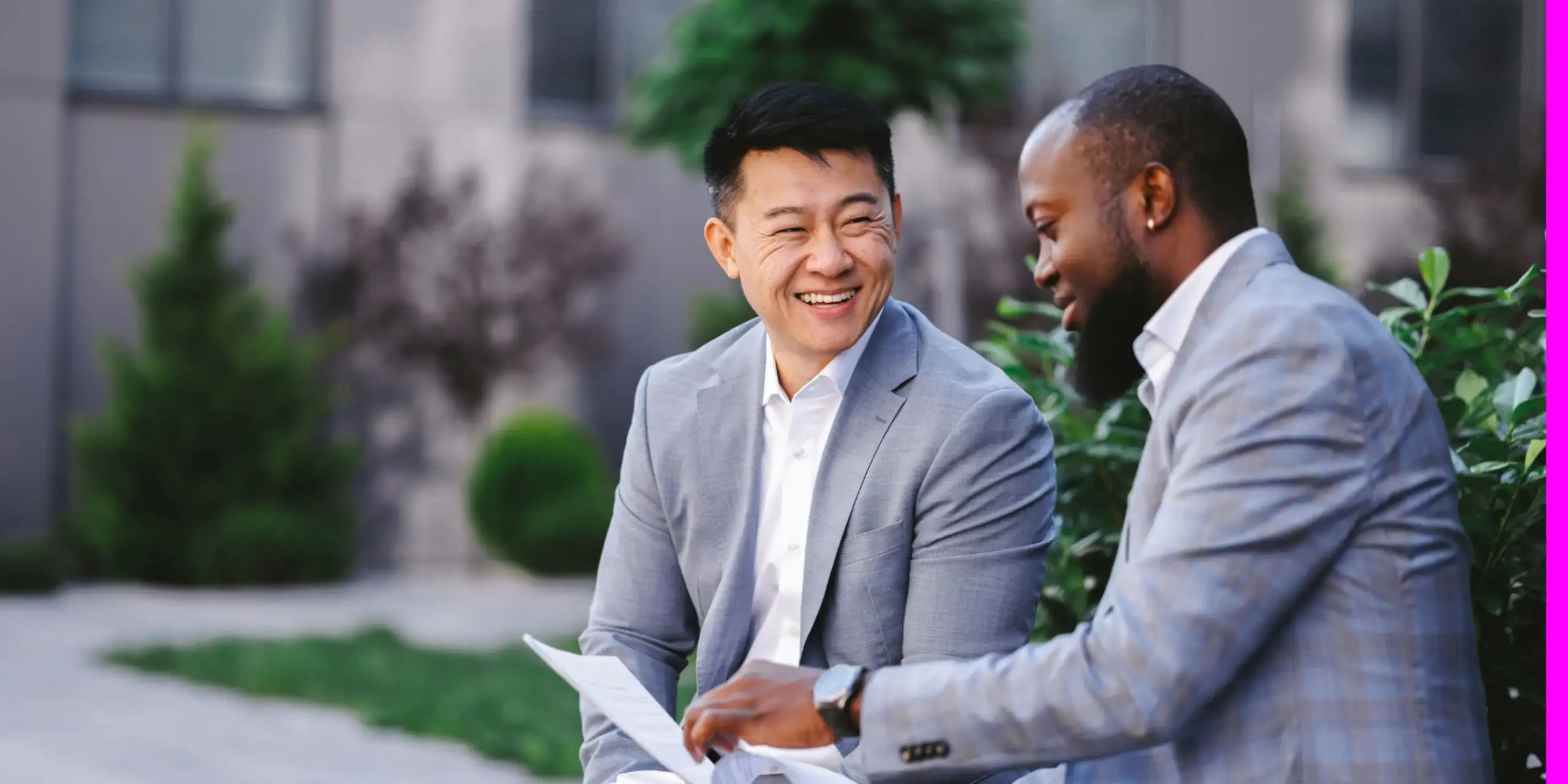 Two professional men referencing a form and collaborating